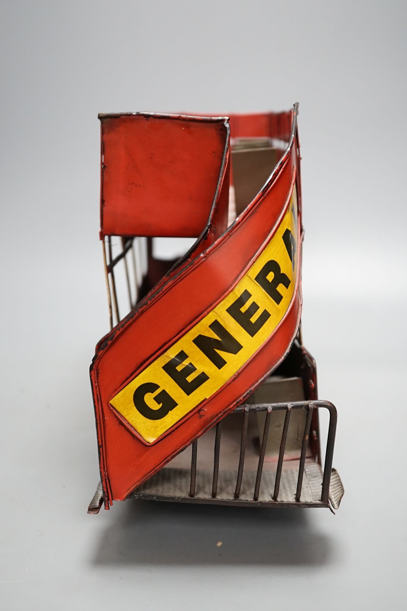 A reproduction tinplate double decker topless bus, the side reading ‘Don’t be vague - ask for Haig’, 42cm long